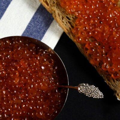 red caviar bali – salmon ikura served on bread, fresh roe from local seafood supplier