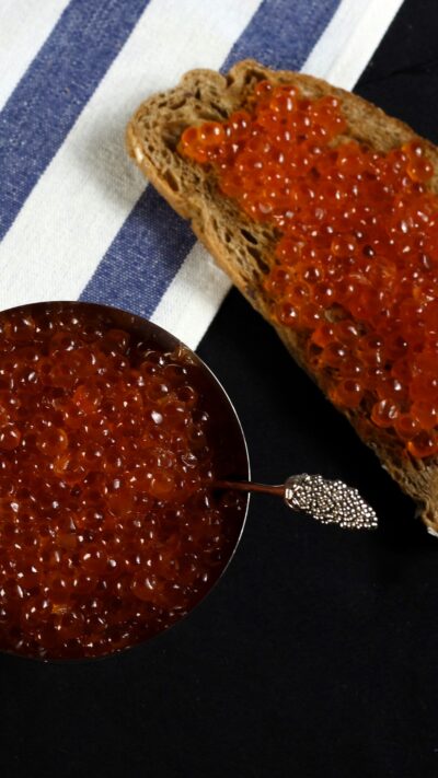 red caviar bali – salmon ikura served on bread, fresh roe from local seafood supplier