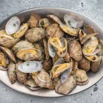 buy clams bali – steamed vongole clams served on metal plate