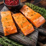 buy salmon bali – raw salmon fillet steaks on wooden board with rosemary