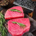 buy tuna steak bali – raw tuna steaks on wooden cutting board