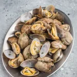 clams delivery bali – steamed clams on silver metal platter