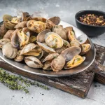 clams bali – steamed clams served on rustic wooden board