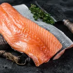 fresh salmon fillet bali – raw salmon fillet on cutting board with knife