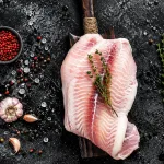 grouper fillet bali – fresh grouper fillet with thyme and garlic on wooden board