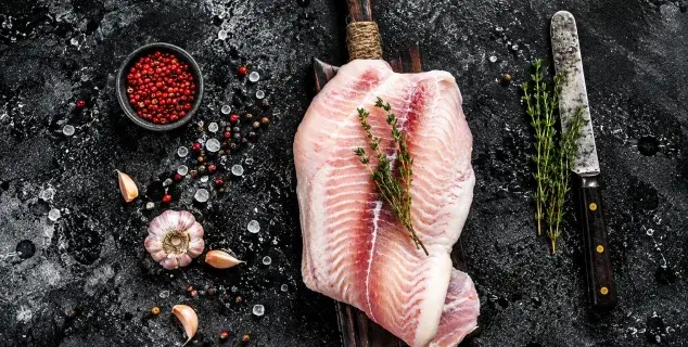 grouper fillet bali – fresh grouper fillet with thyme and garlic on wooden board