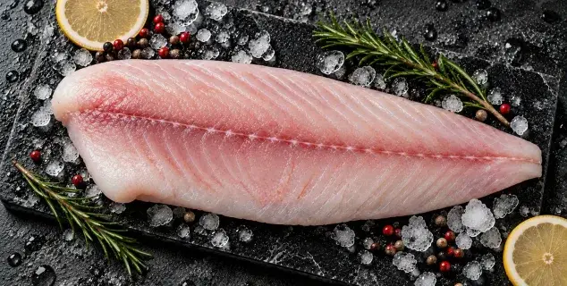 red snapper fillet bali – fresh skinless snapper fillet on ice with lemon and rosemary