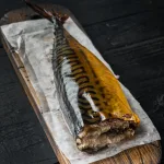 Smoked mackerel Bali — smoked mackerel on a rustic wooden cutting board