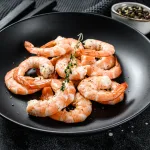 tiger prawn bali – peeled cooked prawns on black plate