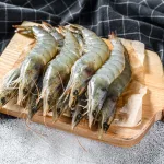 tiger prawn bali – raw tiger prawns with spices on wooden board