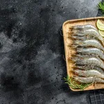tiger prawn bali – whole raw tiger prawns on wooden tray with lime