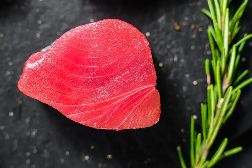 raw tuna steak bali – deep red tuna steak with rosemary sprig