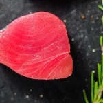 raw tuna steak bali – deep red tuna steak with rosemary sprig